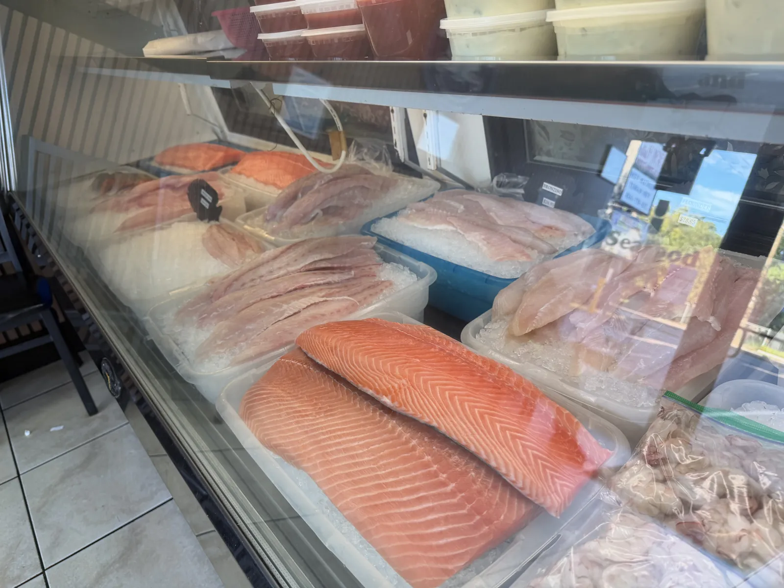 Salmon fillets on ice at the Fountain View Fish Market counter in Houston